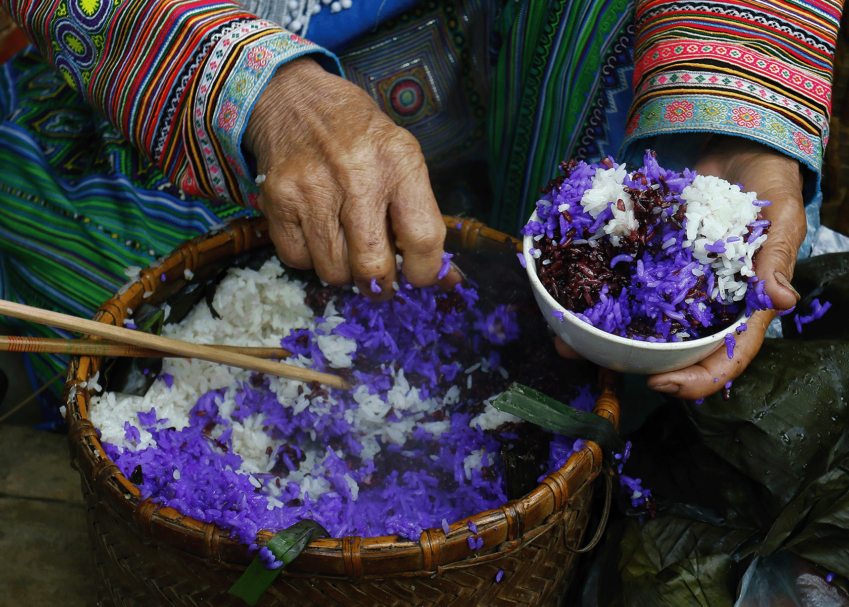 close up of hands and a bowl of flowers