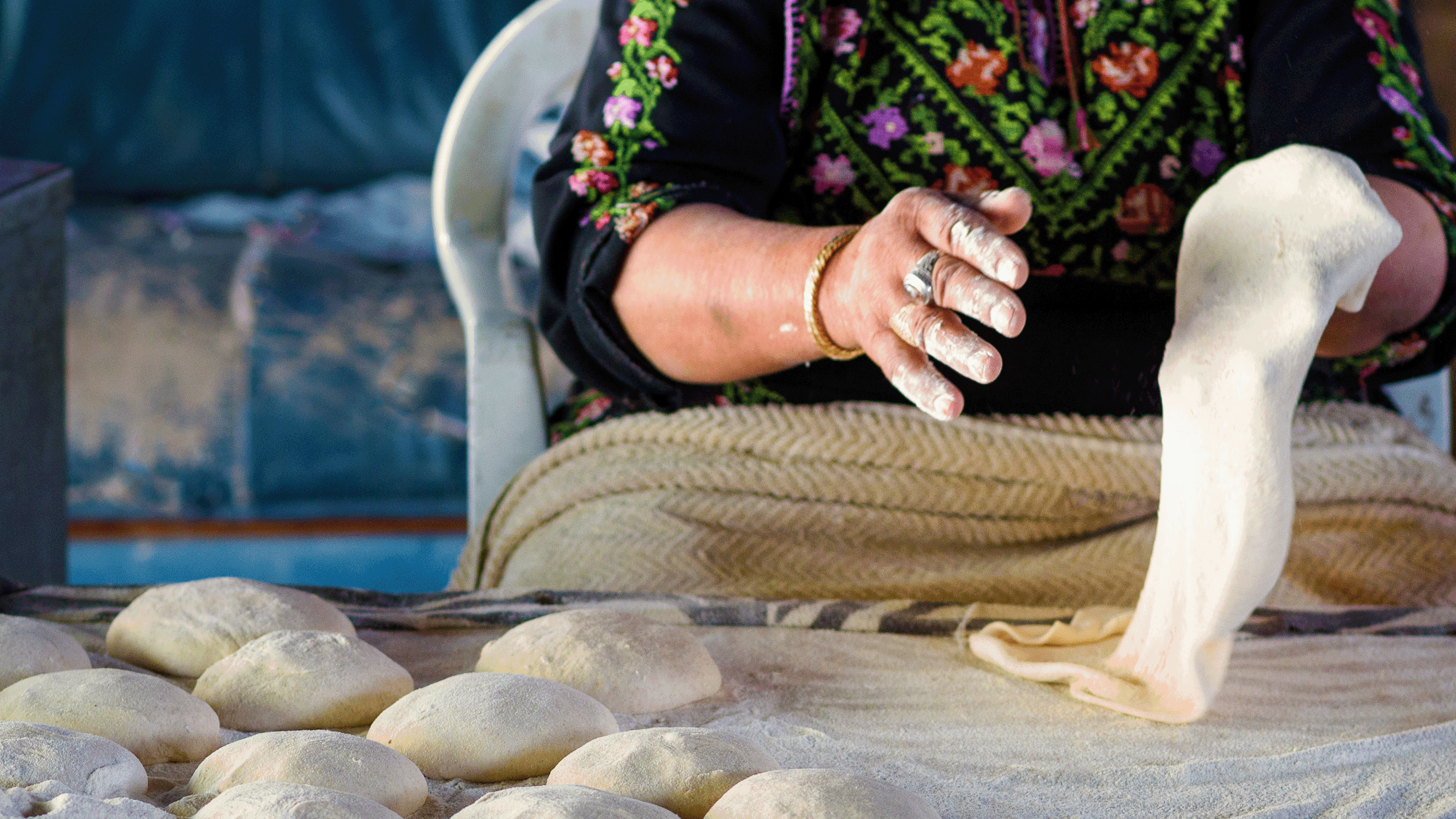 close up of woman'a hands kneading dough