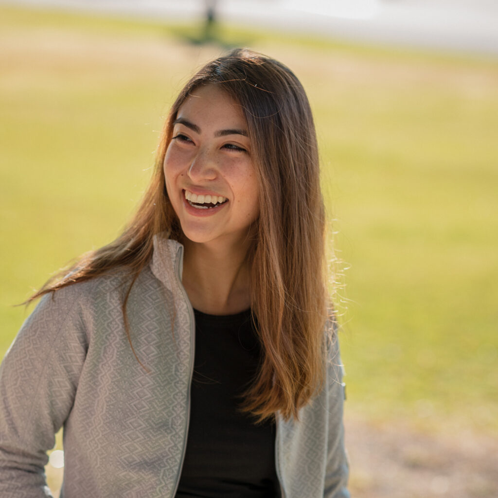 A woman smiles and looks off camera